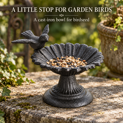 Cast iron flower bird feeder holding birdseed on a garden ledge